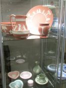 A mixed lot of Wedgwood jasper ware in pink, green and lilac, (2 shelves).