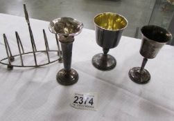 A silver toast rack, a silver spill vase and 2 silver goblets.