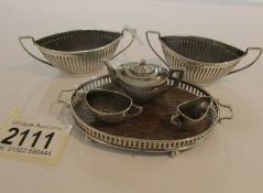 A miniature silver tea set on tray and a pair of silver salts.