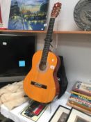 A Hohner accoustic guitar with case (stand not included)