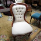 A mahogany framed ladies chair with cream upholstery.