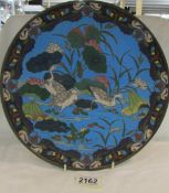 A 19th century Chinese cloissonne blue plate decorated with birds.