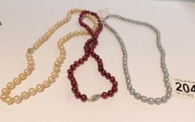 3 Honora pearl necklaces in gold, silver and red colours.