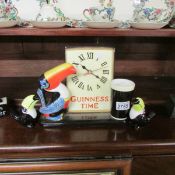 A Guinness clock and 2 Guinness toucans.