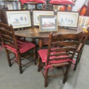 An oval oak gate leg table and a set of 8 oak ladder back chairs.