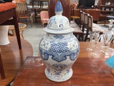 A large blue and white jar with lid.