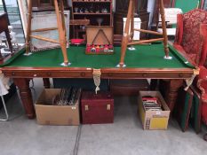 A snooker table (not full size) with balls, score board, cue,