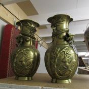 A pair of 19th century brass/bronze Japanese dragon vases, one a/f.