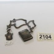 A silver double Albert watch chain with silver vesta case (Birmingham 1901) and a silver fob