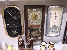 A Martini mirrored wall clock and 2 others.