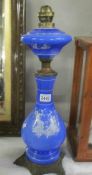 A blue glass and metal oil lamp base with Grecian scene.