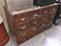 A vintage 12 drawer wooden filing cabinet including tools & screws etc.