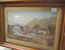 A framed and glazed rural scene watercolour with bridge.