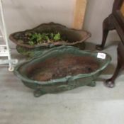 A pair of cast iron planters.