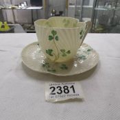 A Belleek tea cup and saucer with black back stamp.
