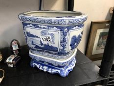 A blue & white planter on stand