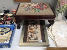 A framed tapestry of cats wearing hats and a tapestry top footstool