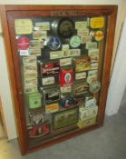 A cased display of vintage tins.