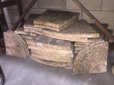 A large lot of paving stones which form a circle for garden decoration