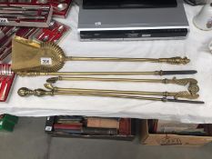 A set of brass fire irons (tongues missing knob)