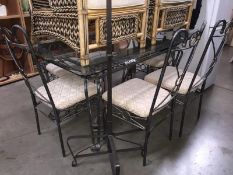 A glass topped steel framed table & 6 chairs (ideal for the garden)