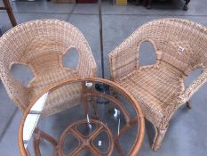 A pair of cane conservatory arm chairs