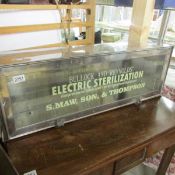 A metal and glass display cabinet with stencilled Bullock & Reynolds advert.