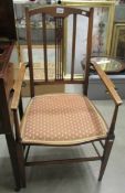 An Edwardian inlaid mahogany elbow chair.