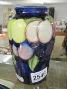 A Moorcroft wisteria vase, approx. 6.25" / 25.75 cm tall.