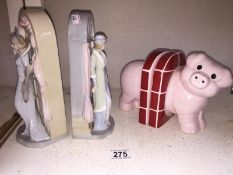 A pair of Lladro style figurine bookends and a pair of Carlton Ware pig bookends