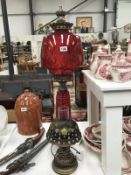 A ruby glass/brass table lamp & 1 other