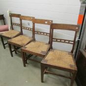 A set of 3 oak dining chairs with rush seats.