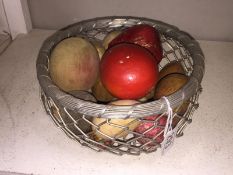 A basket of various eggs including wooden, stone etc.