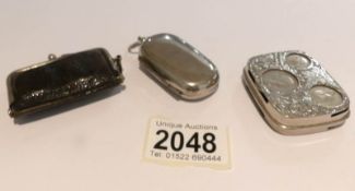 2 white metal coin cases and a coin purse.