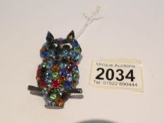 A Butler and Wilson coloured crystal owl brooch,.