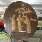 An oval Japanese plaque with 3 figures.