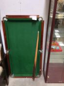 A mahogany slate bed snooker table with cues and balls