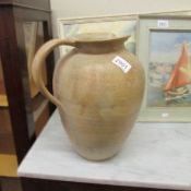 A large stoneware ewer.