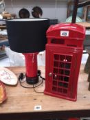 A red telephone box phone and a post box table lamp