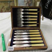 A cased set of fish knives and forks.