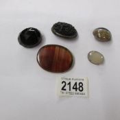 A collection of 5 antique brooches including agate and jet.