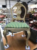 A painted French chair with ormolu decoration and striped seat