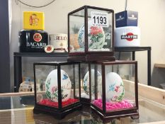 4 handpainted eggs in display cabinet