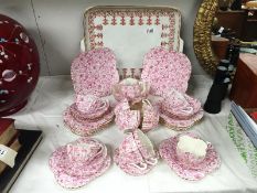 An Edwardian pink and white tea set and tray (1 cup a/f)