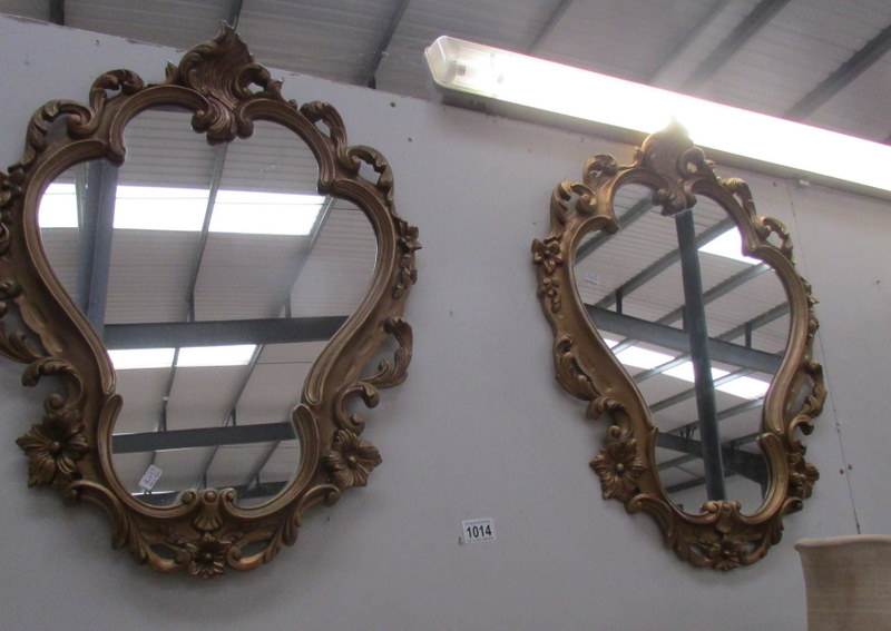A pair of gilt framed shield shaped mirrors.