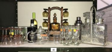 A shelf of breweriana drinking glasses, decanters, Pimms, winter, teapot etc.