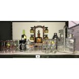 A shelf of breweriana drinking glasses, decanters, Pimms, winter, teapot etc.