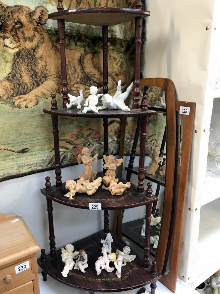 A quantity of cherub angel figures and stand