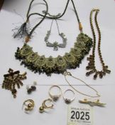 A mixed lot of jewellery including necklace with matching brooch, white stone necklace,