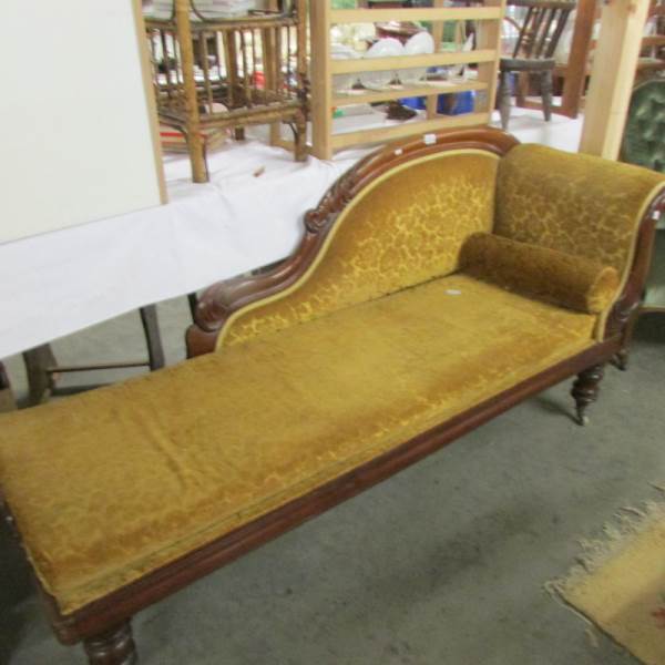 A mahogany framed chaise longue.